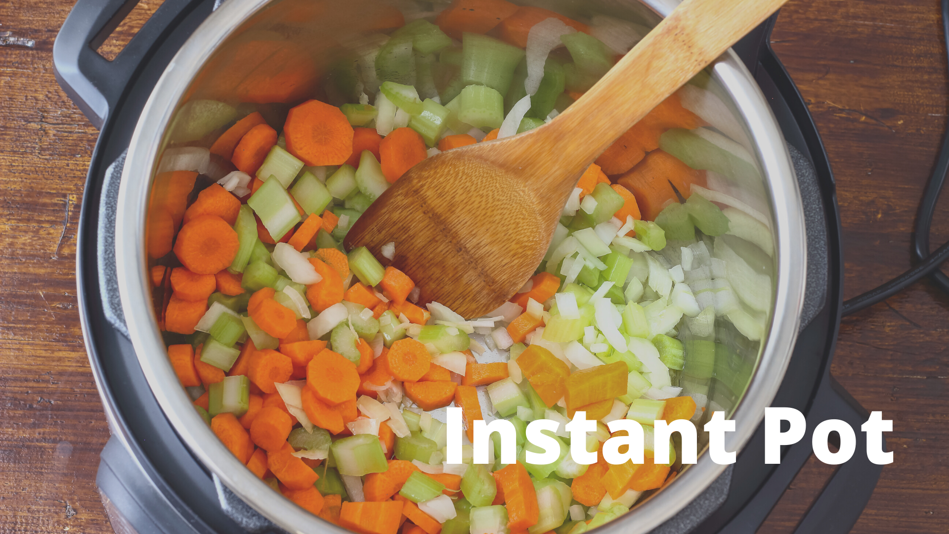 Instant Pot full of fresh chopped vegetables — carrots, celery, and onions ready for pressure cooking